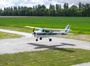Cessna 172 is landing. Small airplane in the sky, student is learning how to land on the ground.