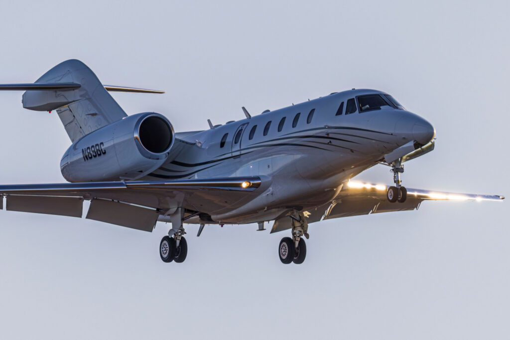 A Cessna Citation X comes in for a landing at Centennial Airport at sunset.