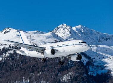 huge private jet (airliners size) arriving at the highest airport in europe with a beautiful mountain scenery in the background